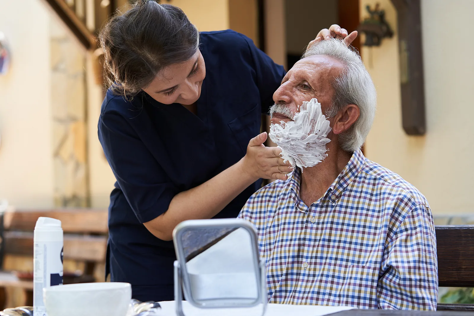 Caregiver gently assisting a resident with morning grooming