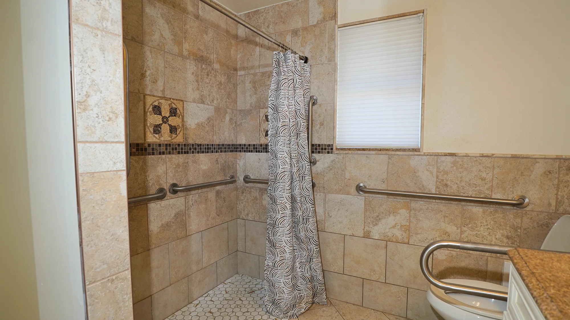 Tiled walk-in shower with grab bars